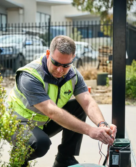 Technician servicing an automatic gate motor in Mandurah, Western Australia